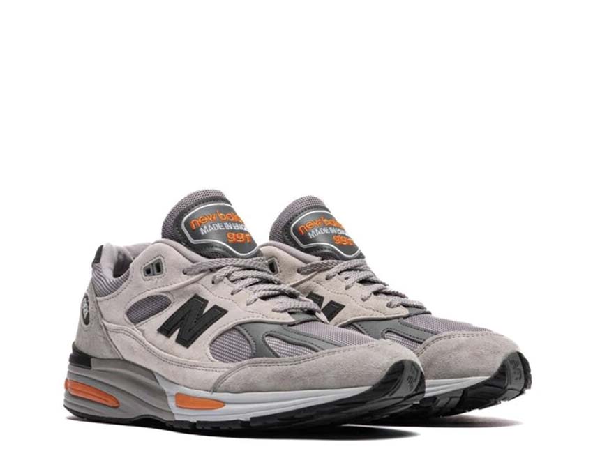 New Balance 991v2 Made in UK Pelican Grey Orange vue latérale — accents orange vif
